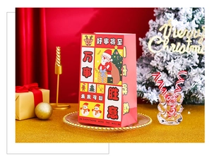 Close-up of festive red Christmas paper gift bag with illustrations and gold decorations