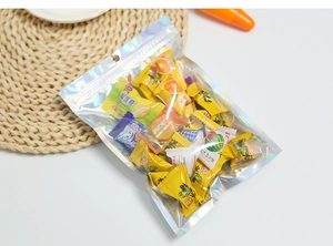 Detailed shot of holographic resealable bag filled with assorted fruit candies on a mat