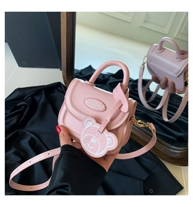 Pink mini crossbody bag featuring a cute bear charm and mirror reflection detail