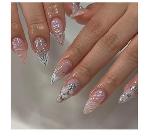 Detail of nude pink Y2K press-on nails with 3D silver wavy lines and heart patterns