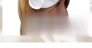 Macro view of a white fascinator hat with elegant wavy mesh texture and floral accents