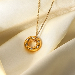 18K gold plated stainless steel necklace with hollow round zircon pendant on beige silk