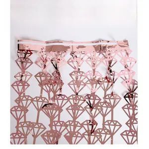 Detailed macro view of rose gold diamond-shaped foil fringe curtain for party decor