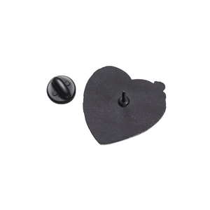 Detail view of heart-shaped enamel pin back with black rubber clutch and metal pin base
