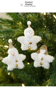 Close-up of white plush Christmas tree ornaments with golden bells on festive branches