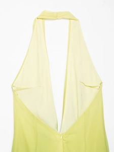 Detail of lime green deep V-neck halter dress with back zipper and chiffon texture