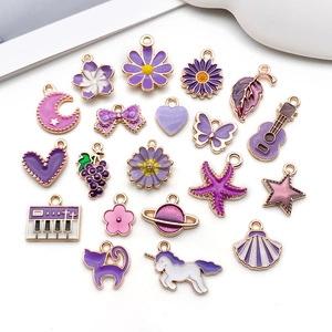 Flat lay of purple enamel alloy charms featuring stars, hearts and animal shapes