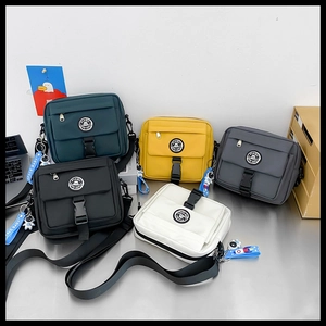 Five colors of Japanese techwear crossbody bags with PINBO logo on a metal surface
