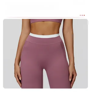 Détail du pantalon de yoga à taille haute avec ceinture contrastée blanche et effet deux pièces