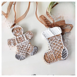 Detail of gingerbread man and stocking resin ornaments with brown organza ribbons