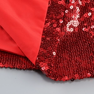Close-up of vibrant red sequins and smooth polyester fabric stitching detail on the skirt