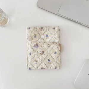 Quilted cotton storage pouch with blue floral rabbit print and white button closure