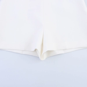 Close-up of premium fabric texture and precise stitching on white tailored shorts