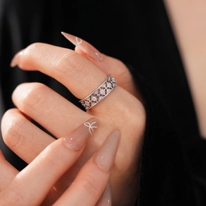 Detailed close-up of a silver floral open ring with delicate micro-paved cubic zirconia