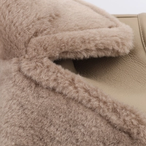 Detail of faux shearling texture and premium lychee pattern leather on a reversible jacket