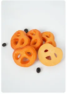 Detailed macro view of a realistic golden PVC butterfly cookie food model with coffee beans