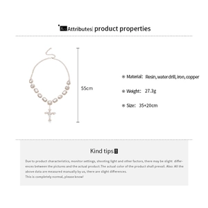 Detail view of silver cross pendant necklace with resin rhinestones and metal specs