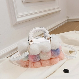Detail of colorful plush faux fur handbag with white leather handle and metal rings