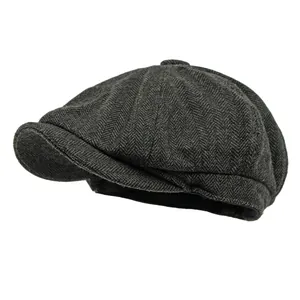 Classic dark grey herringbone newsboy cap made of high-quality wool tweed fabric