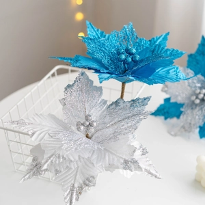 Detailed view of blue and silver fabric Christmas poinsettia flowers with glitter texture