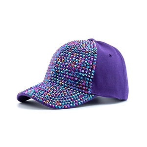 Detail of purple baseball cap with colorful rhinestones and sparkling gems decoration