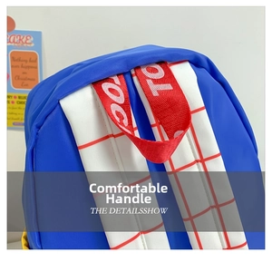 Close-up of blue canvas backpack handle with red webbing and checkered straps detail