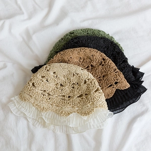 Detail of hollow woven straw hats with chiffon ruffled edges in multiple soft colors