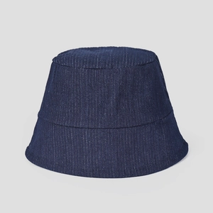 Detail of dark blue denim bucket hat featuring white vertical pinstripe fabric texture