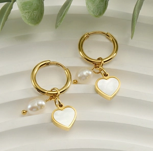 Detail of 18K gold stainless steel hoop earrings with heart charms and natural white pearls