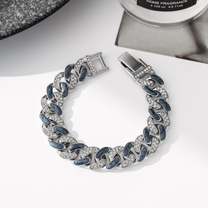 Silver Cuban link bracelet with dark blue enamel and crystals on a white surface
