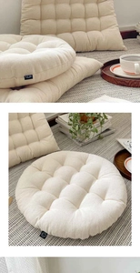 Close-up of thick beige tatami seat cushion showing cotton linen texture and quilted details
