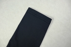Detail of double-needle stitching and fabric texture on dark blue knitted skirt set