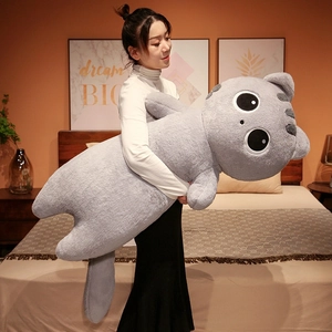 Detailed view of the large grey cat plush pillow held by a model for size perspective