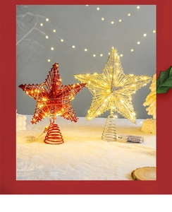 Detailed view of red and gold star tree toppers with LED light strings and spring bases