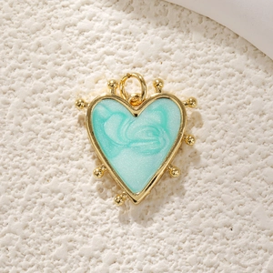 Detailed close-up of a heart-shaped pendant with gold frame and blue marble inlay texture