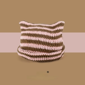 Close-up of pink and brown striped crochet knit beanie with cat ear design and rolled edge