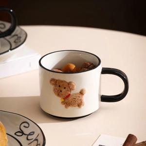 Detail of ceramic coffee mug featuring 3D brown dog relief and matching Sen saucer
