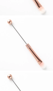 Detail of rose gold DIY beaded makeup brush with soft white and pink gradient bristles
