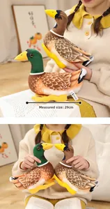 Detail view of 29cm realistic mallard plush duck toys held in a cozy home setting