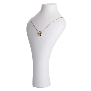 Golden heart necklace with crystal pendant on white minimalist portrait display stand