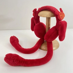Detail of red plush ear muffs with gold Fu character embroidery for New Year