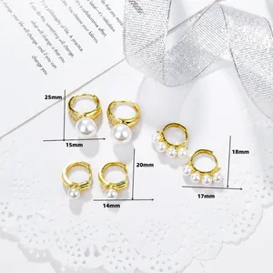 Detailed view of three 18K gold-plated copper earrings with pearls and cubic zirconia