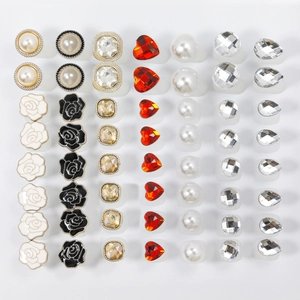 Close-up display of various gemstone and pearl stud earrings in a neat grid layout