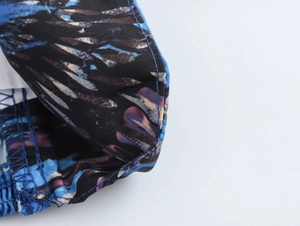 Close-up of abstract blue and purple print fabric with professional blue stitching details