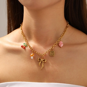 Golden stainless steel necklace with cherry mushroom bow heart pendants worn by model
