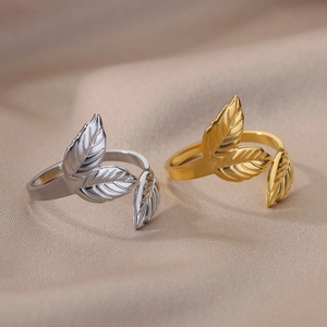 Detail of adjustable leaf texture rings in silver and gold plating on fabric