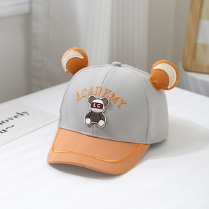 Detail of baby baseball cap with cute bear ears and Academy embroidery in grey and orange