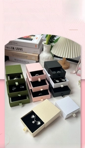 Detail of sliding drawer jewelry box with satin ribbon handle and velvet lining