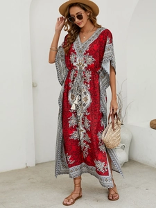 Detail of V-neck bohemian kaftan with intricate ethnic patterns and drawstring waist