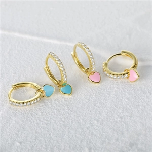 Detail of pink and blue heart earrings with gold base and sparkling zircon accents